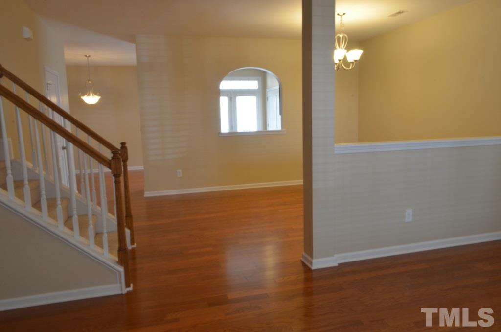 509 Dragby Lane Raleigh, NC 27603 - Photo 5 of 25 en empty room with wooden floor and windows