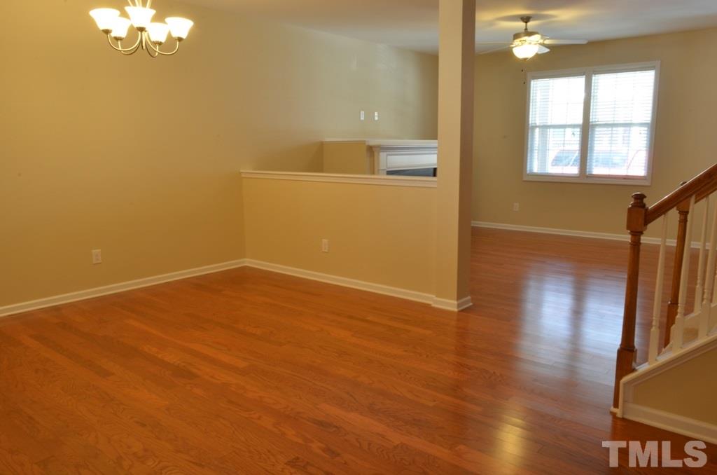 509 Dragby Lane Raleigh, NC 27603 - Photo 7 of 25 an empty room with wooden floor and windows