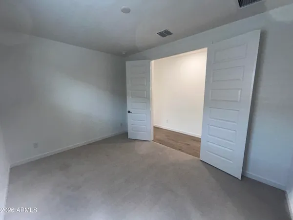 a view of an empty room and closet