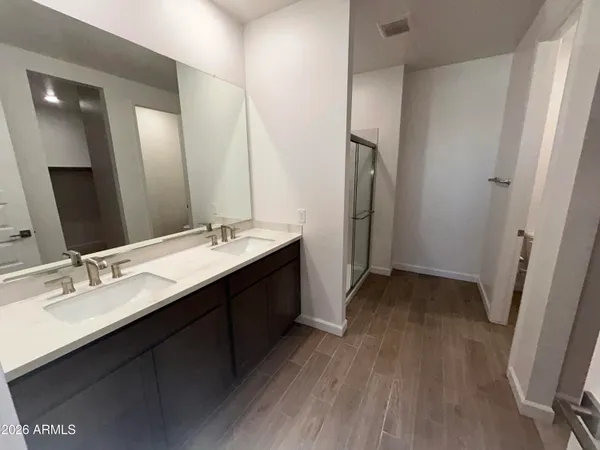 a bathroom with a double vanity sink and mirror