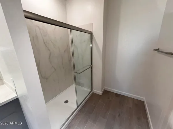 a bathroom with a glass shower door