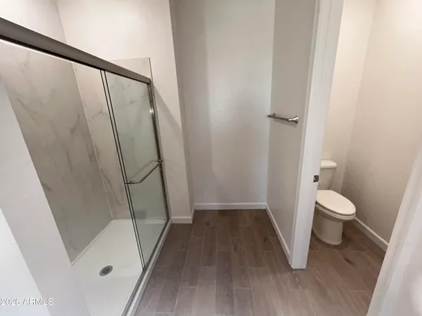 a bathroom with a toilet and a shower