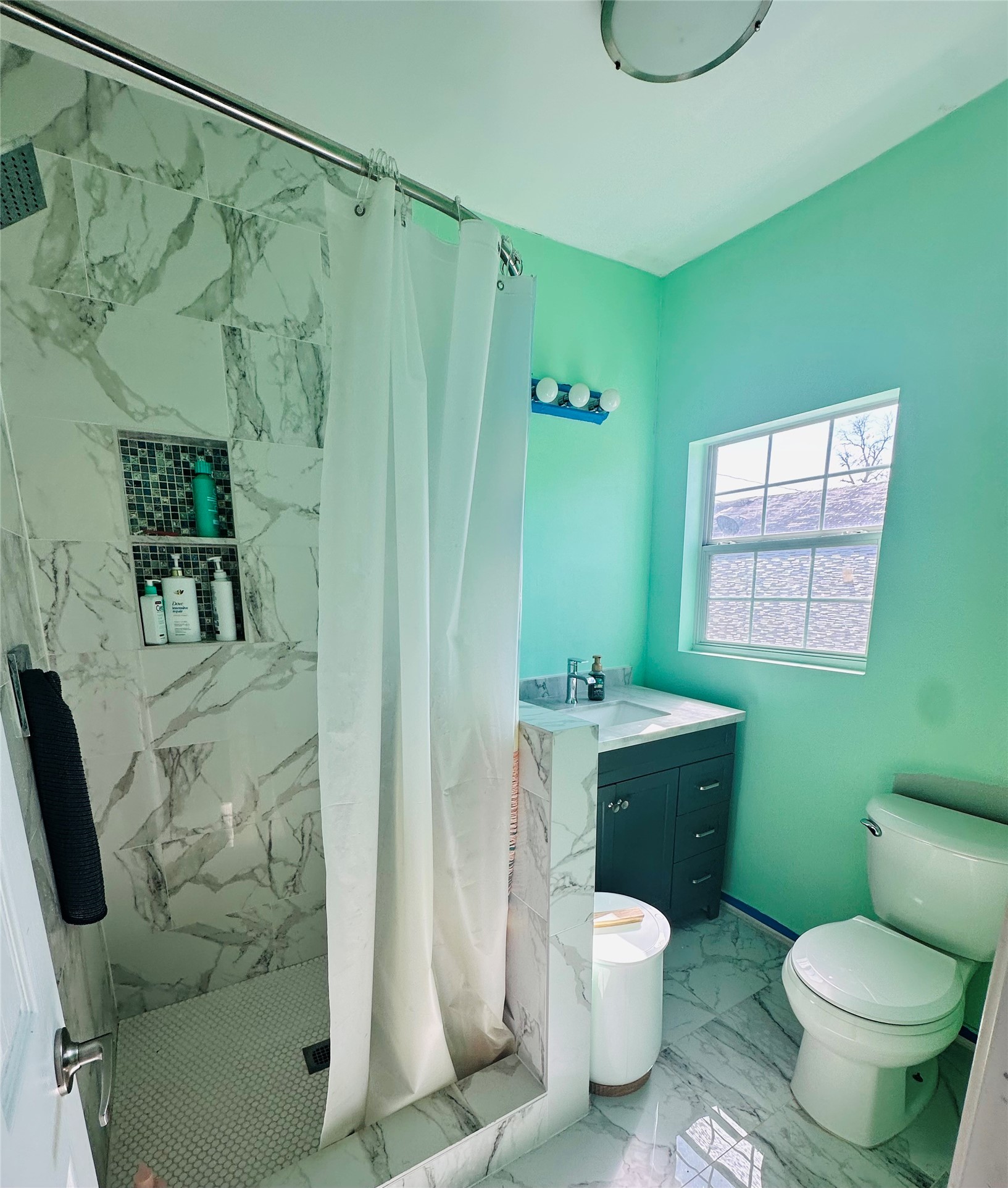 323 North Outlar Street Wharton, TX 77488 - Photo 13 of 25 a bathroom with a granite countertop toilet sink and mirror