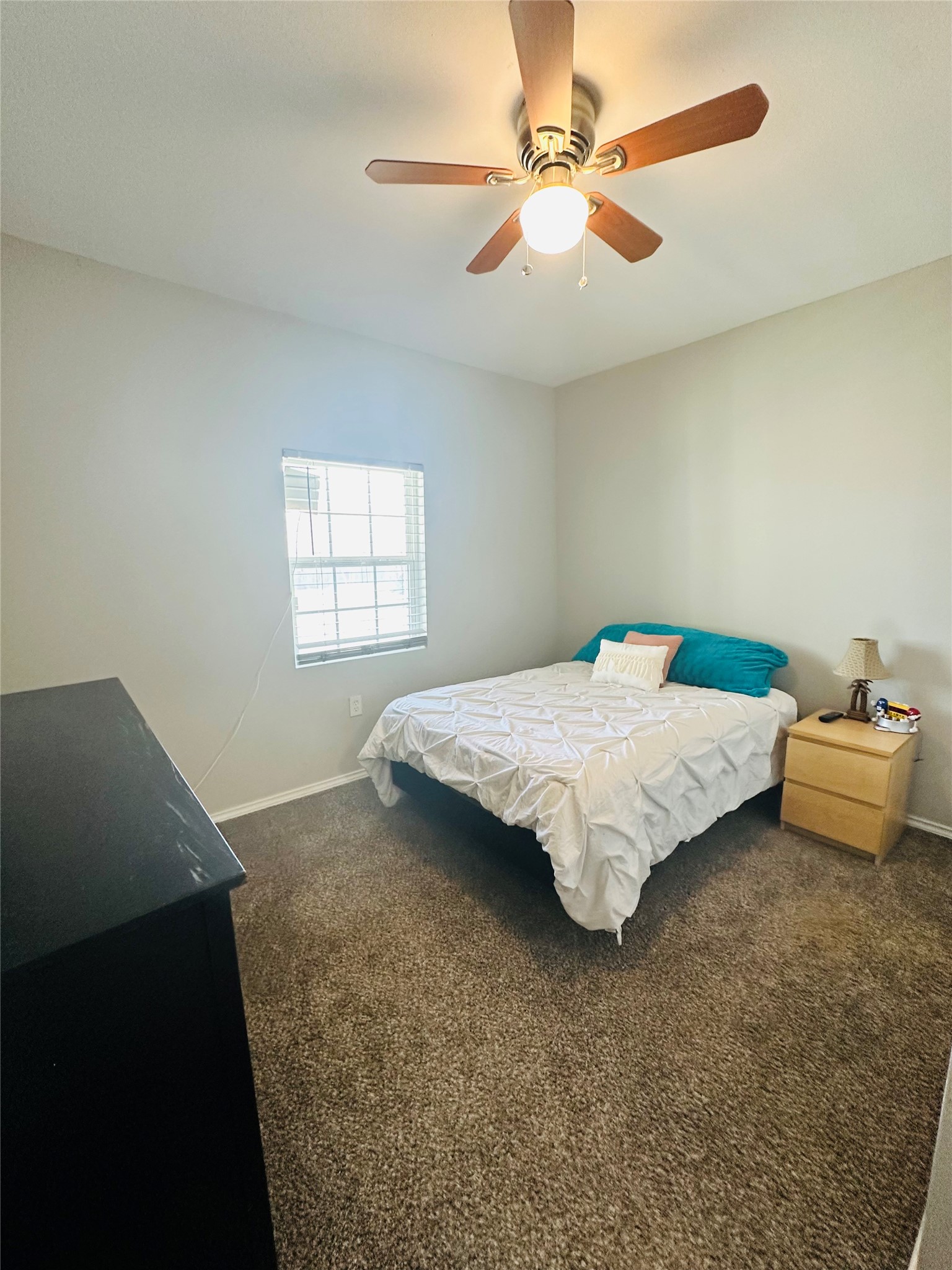 323 North Outlar Street Wharton, TX 77488 - Photo 14 of 25 a bedroom with a bed and a chandelier