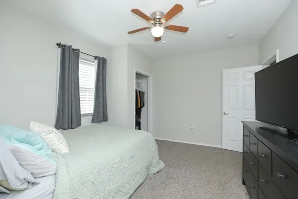 a bedroom with a bed and a flat screen tv