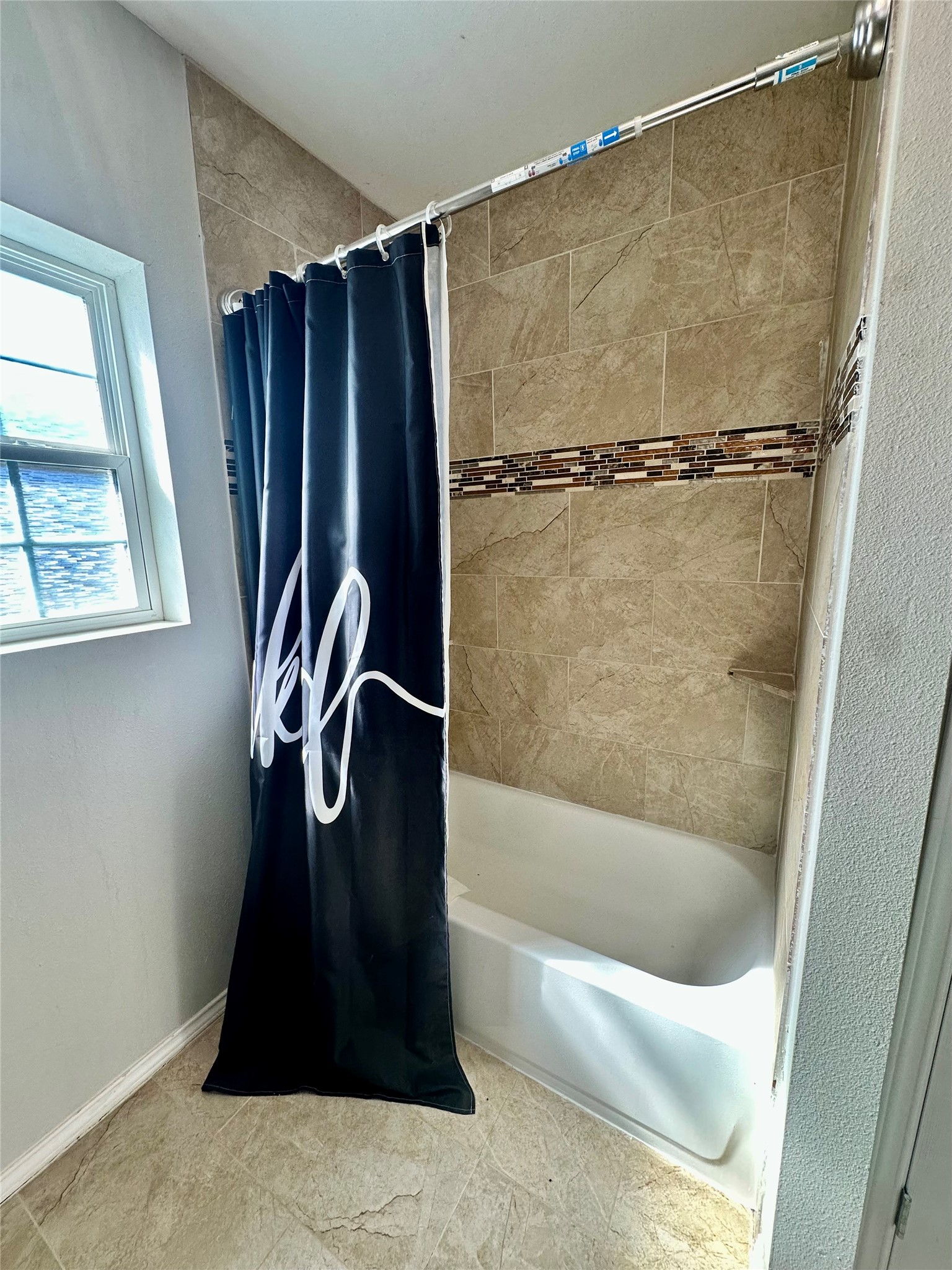 323 North Outlar Street Wharton, TX 77488 - Photo 17 of 25 a bathroom with a shower and a tub