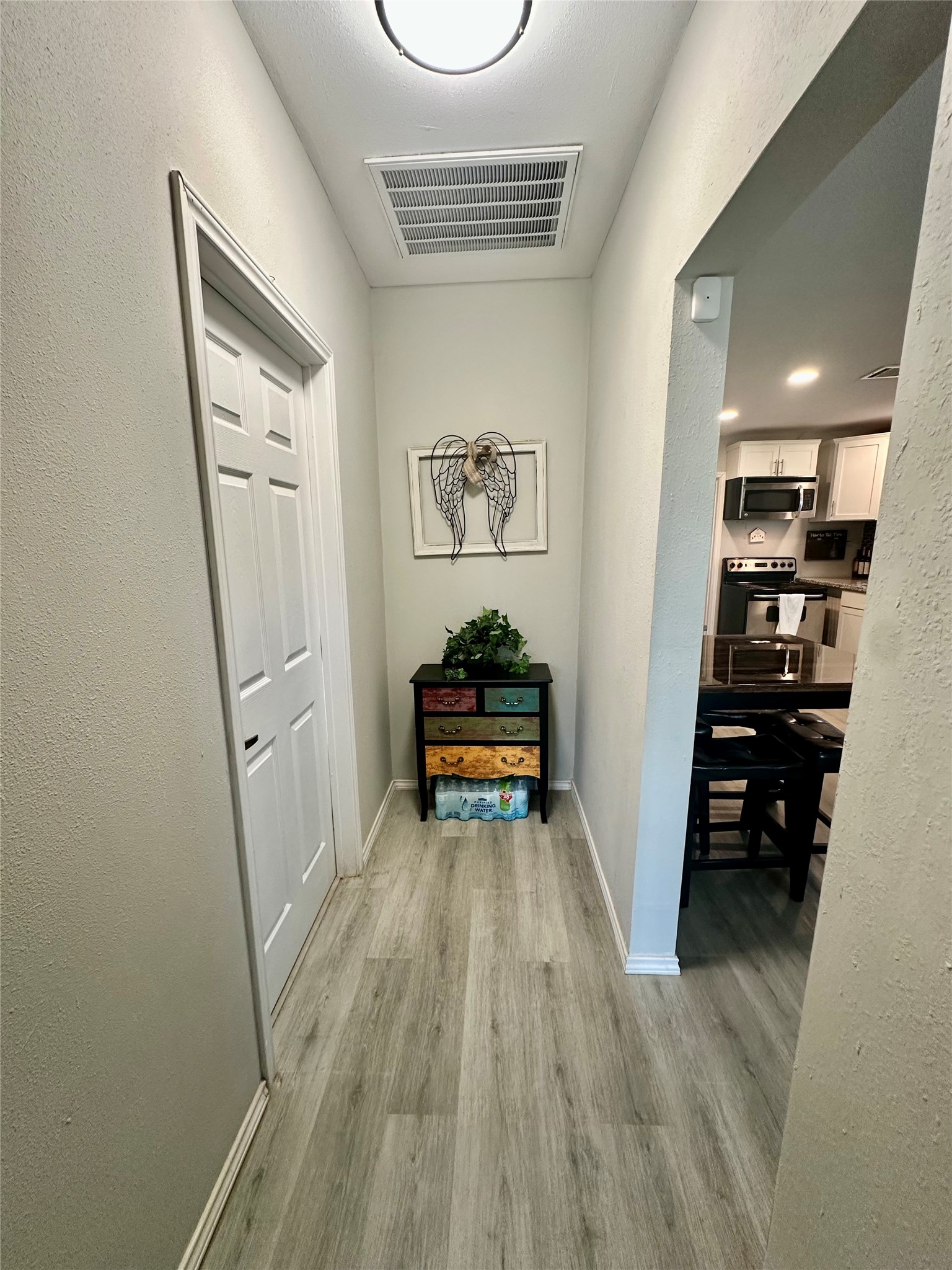 323 North Outlar Street Wharton, TX 77488 - Photo 18 of 25 a view of a hallway to a livingroom with furniture wooden floor and window