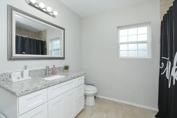 a view of a hallway to a livingroom with furniture