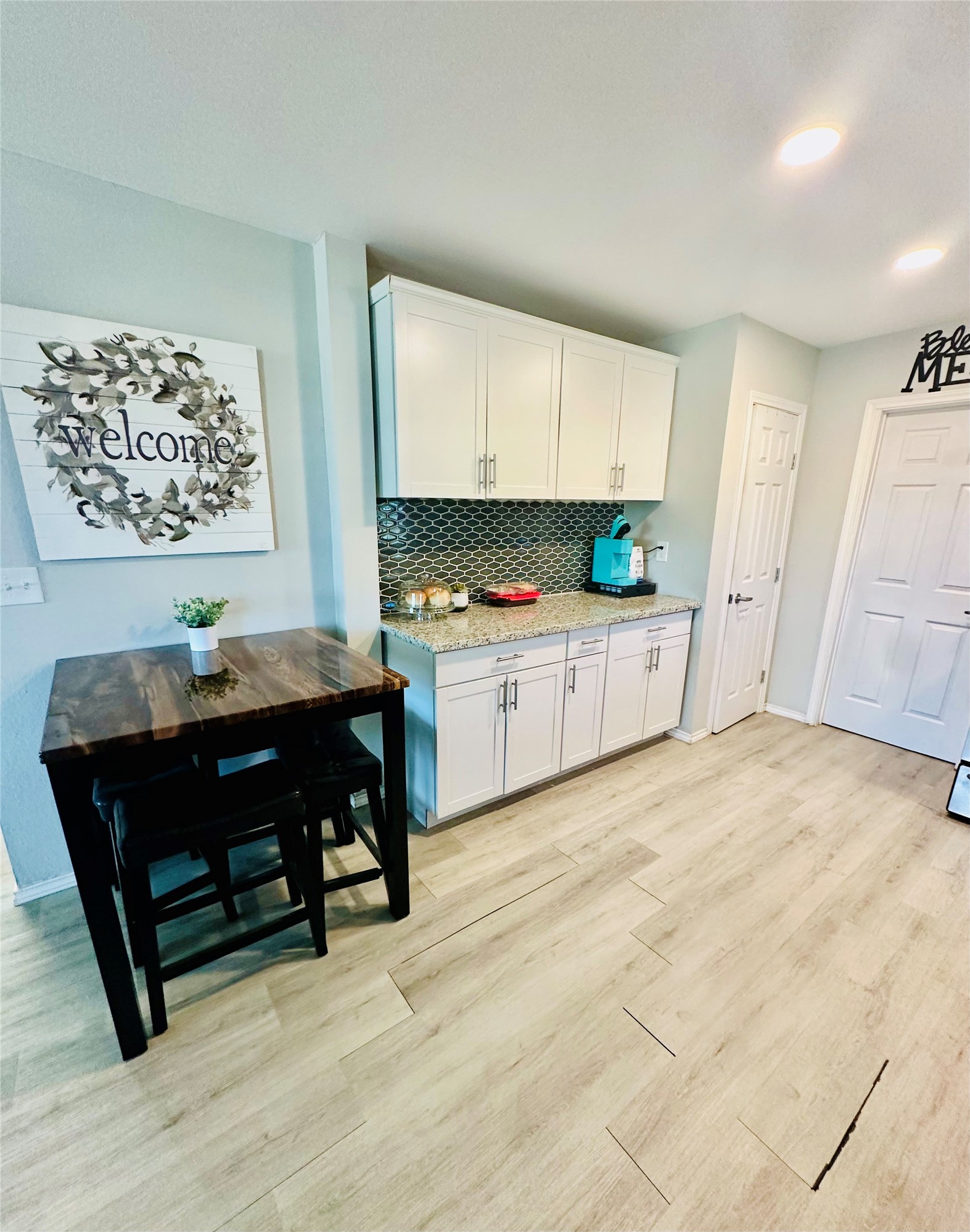 323 North Outlar Street Wharton, TX 77488 - Photo 6 of 25 a living room with stainless steel appliances kitchen island granite countertop furniture and a wooden floor