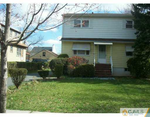 1257 Brookside Road Piscataway, NJ 08854 - Photo 1 of 8 a view of a brick house with a yard and plants