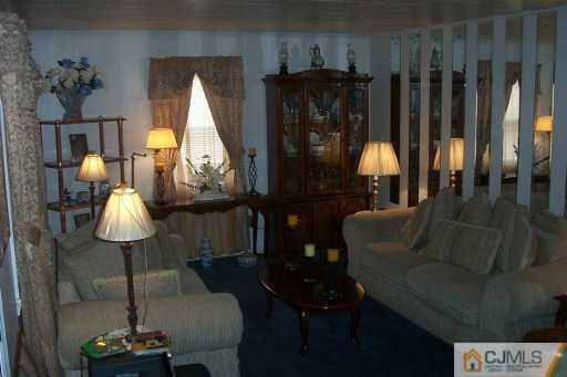 1257 Brookside Road Piscataway, NJ 08854 - Photo 4 of 8 a living room with couches chairs and a chandelier