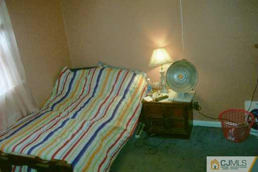 1257 Brookside Road Piscataway, NJ 08854 - Photo 6 of 8 a bedroom with a bed and gym equipment