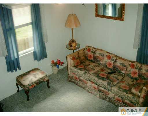 1257 Brookside Road Piscataway, NJ 08854 - Photo 7 of 8 a bedroom with a bed and a chandelier