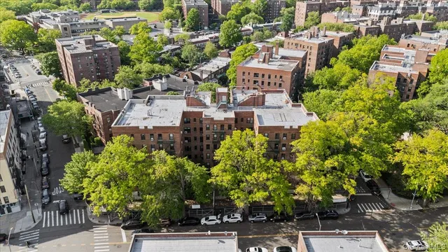 an aerial view of residential house with outdoor space and trees all around
