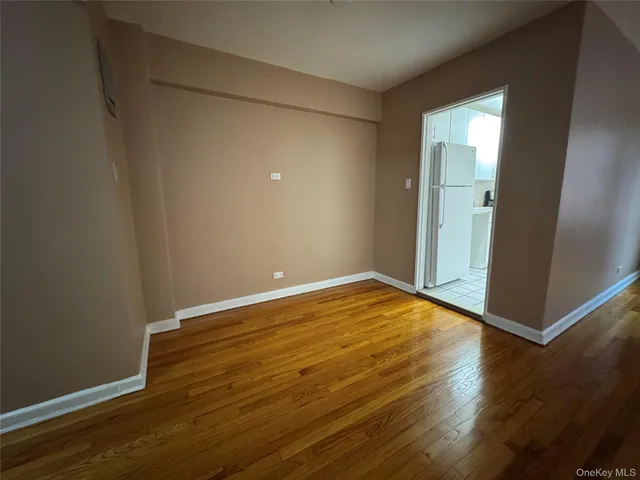 an empty room with wooden floor and closet