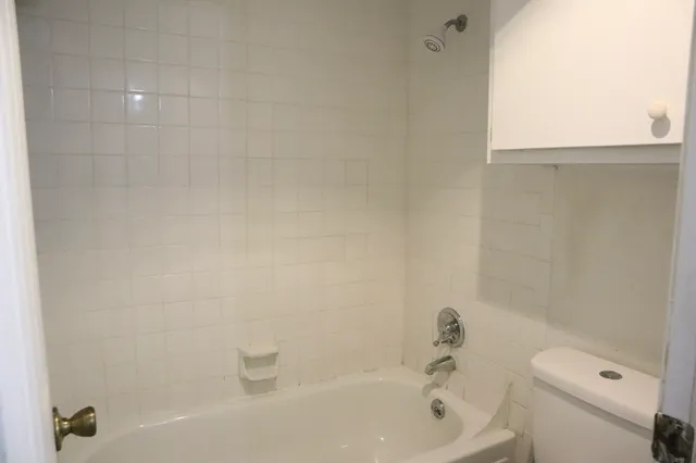 a bathroom with a bathtub and a toilet