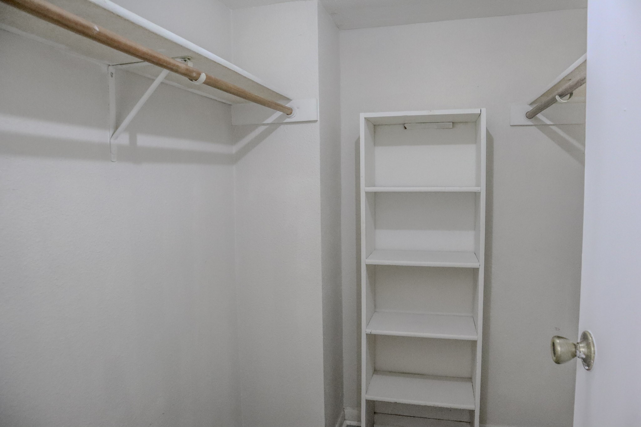 10912 Gulf Freeway, Unit 25 Houston, TX 77075 - Photo 14 of 23 a view of walk in closet with empty racks