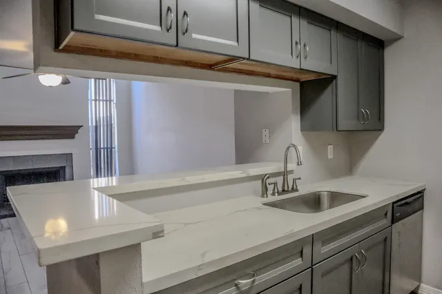 a kitchen with a sink and cabinets