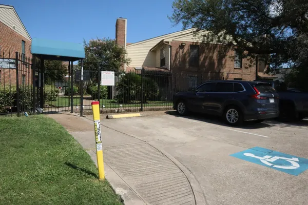 a view of a car parked in front of a building