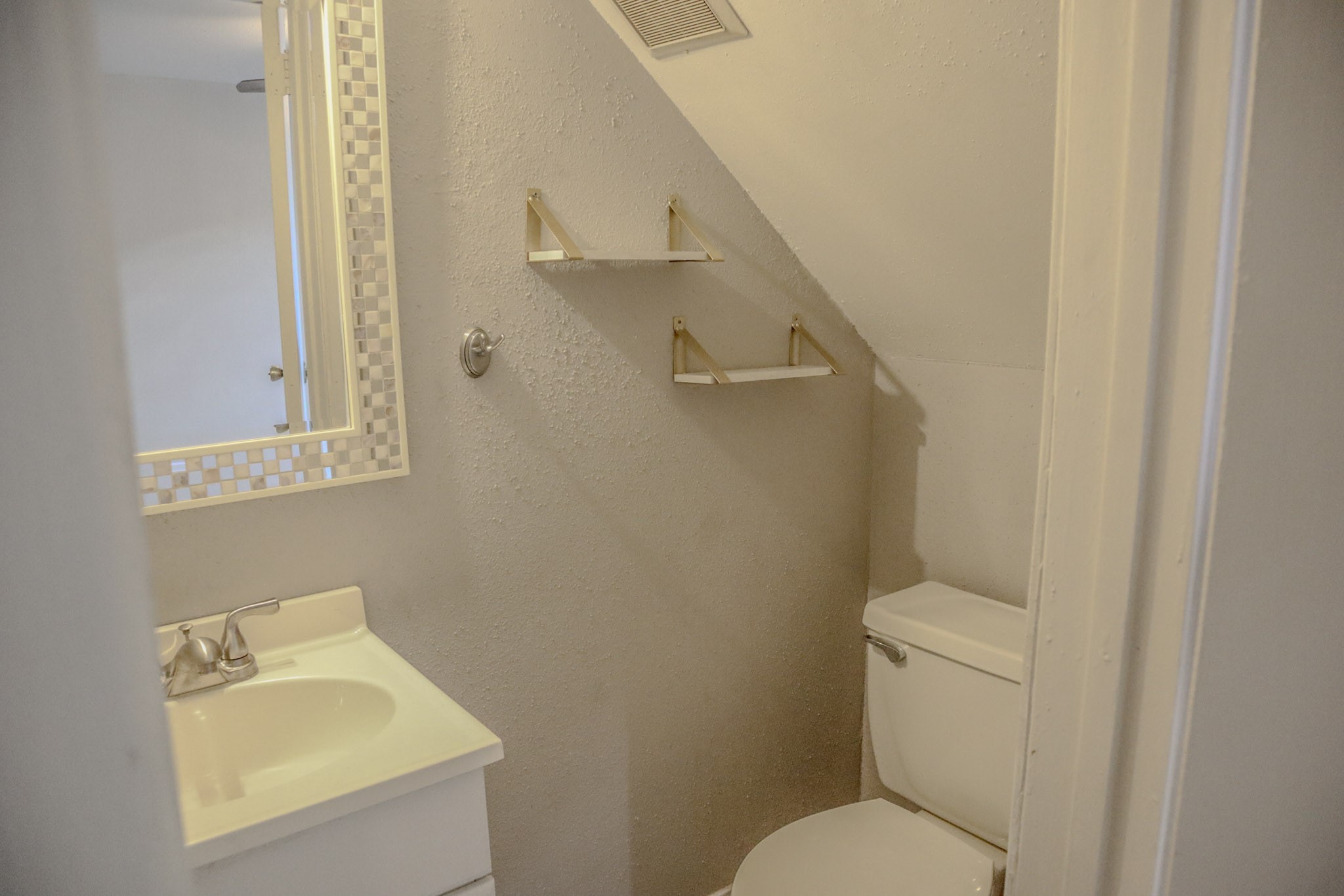 10912 Gulf Freeway, Unit 25 Houston, TX 77075 - Photo 4 of 23 a bathroom with a toilet sink and mirror