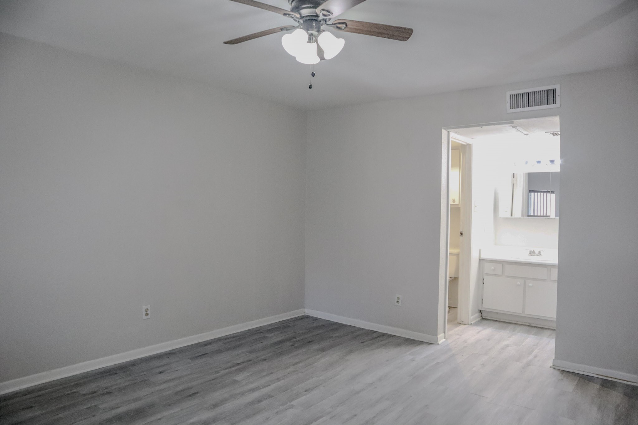 10912 Gulf Freeway, Unit 25 Houston, TX 77075 - Photo 8 of 23 wooden floor in an empty room with a window