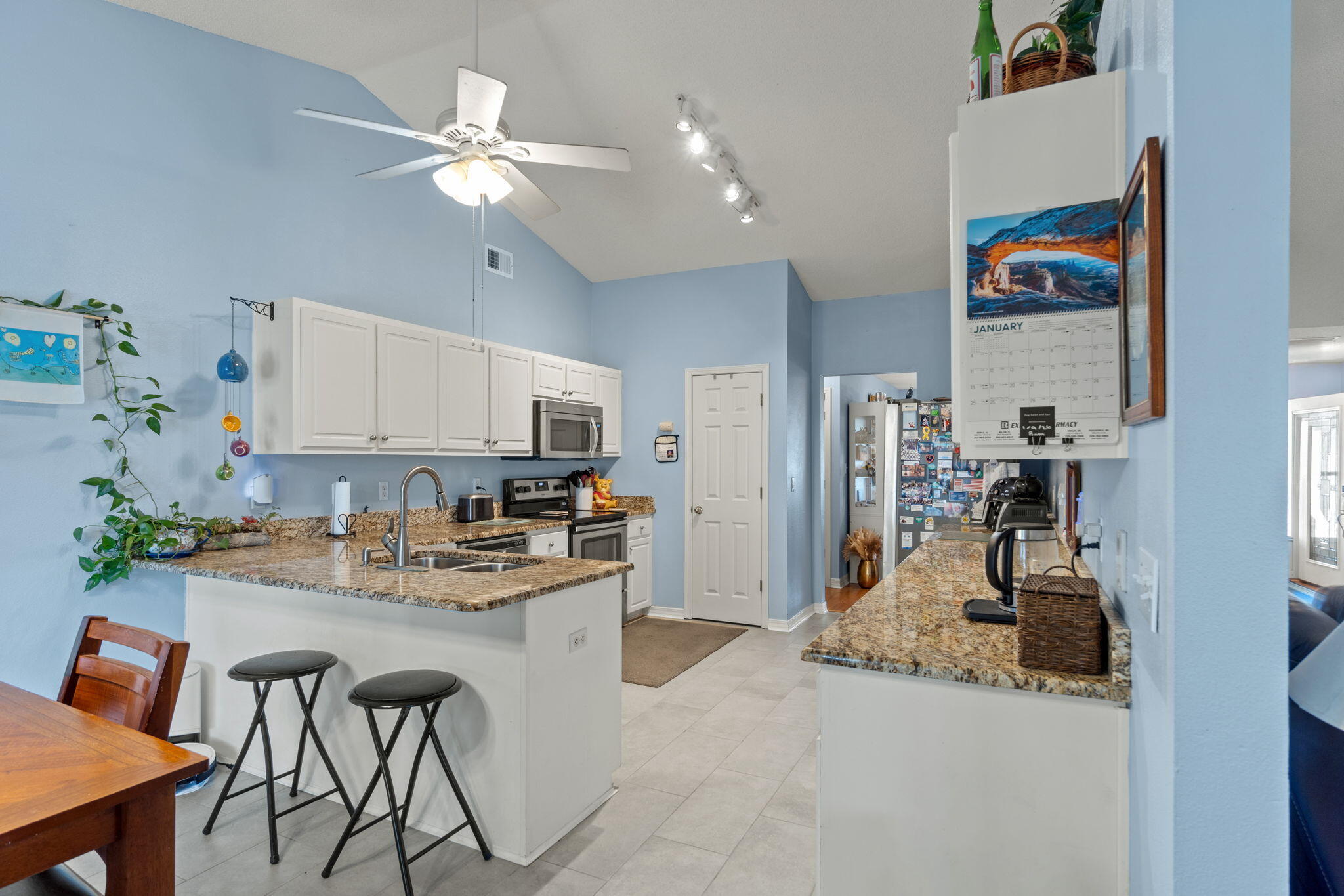 2121 Ortega Street Navarre, FL 32566 - Photo 13 of 47 a kitchen with stainless steel appliances granite countertop a refrigerator and a stove top oven
