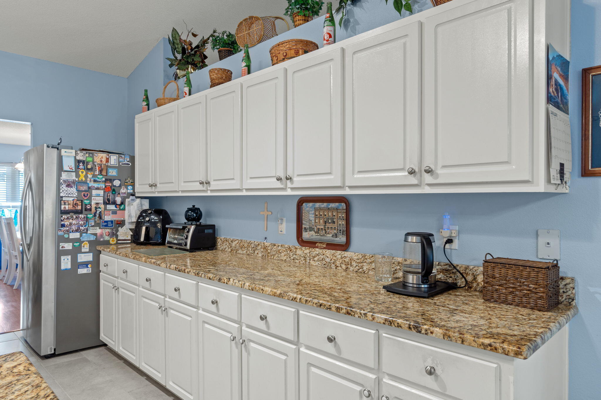 2121 Ortega Street Navarre, FL 32566 - Photo 14 of 47 a kitchen with stainless steel appliances granite countertop white cabinets and a sink