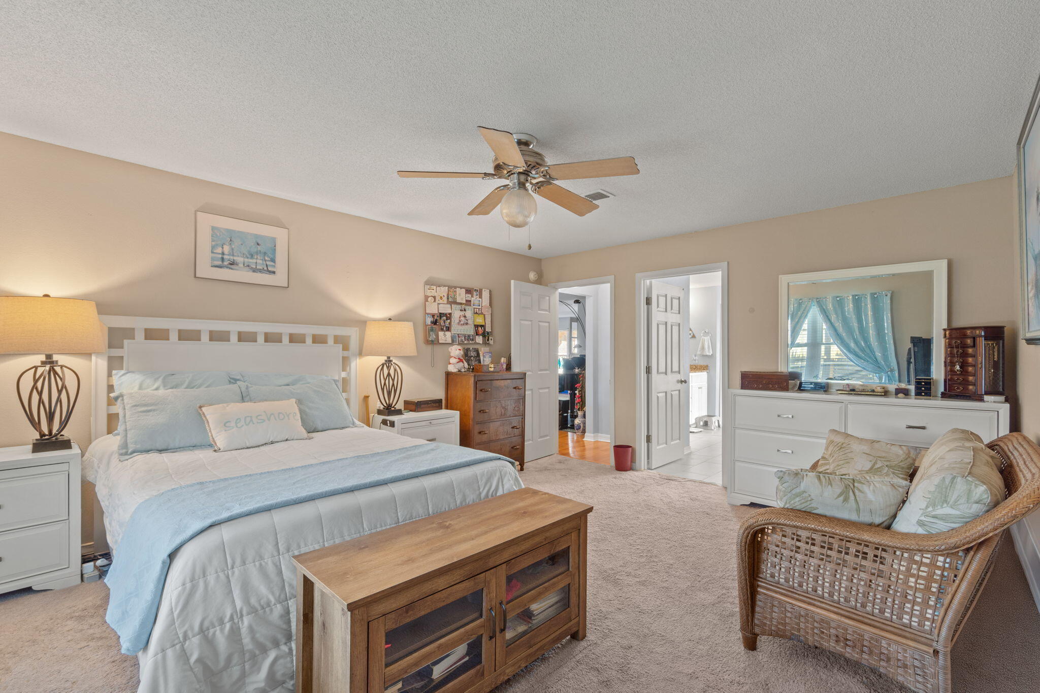 2121 Ortega Street Navarre, FL 32566 - Photo 19 of 47 a spacious bedroom with a bed and a couch