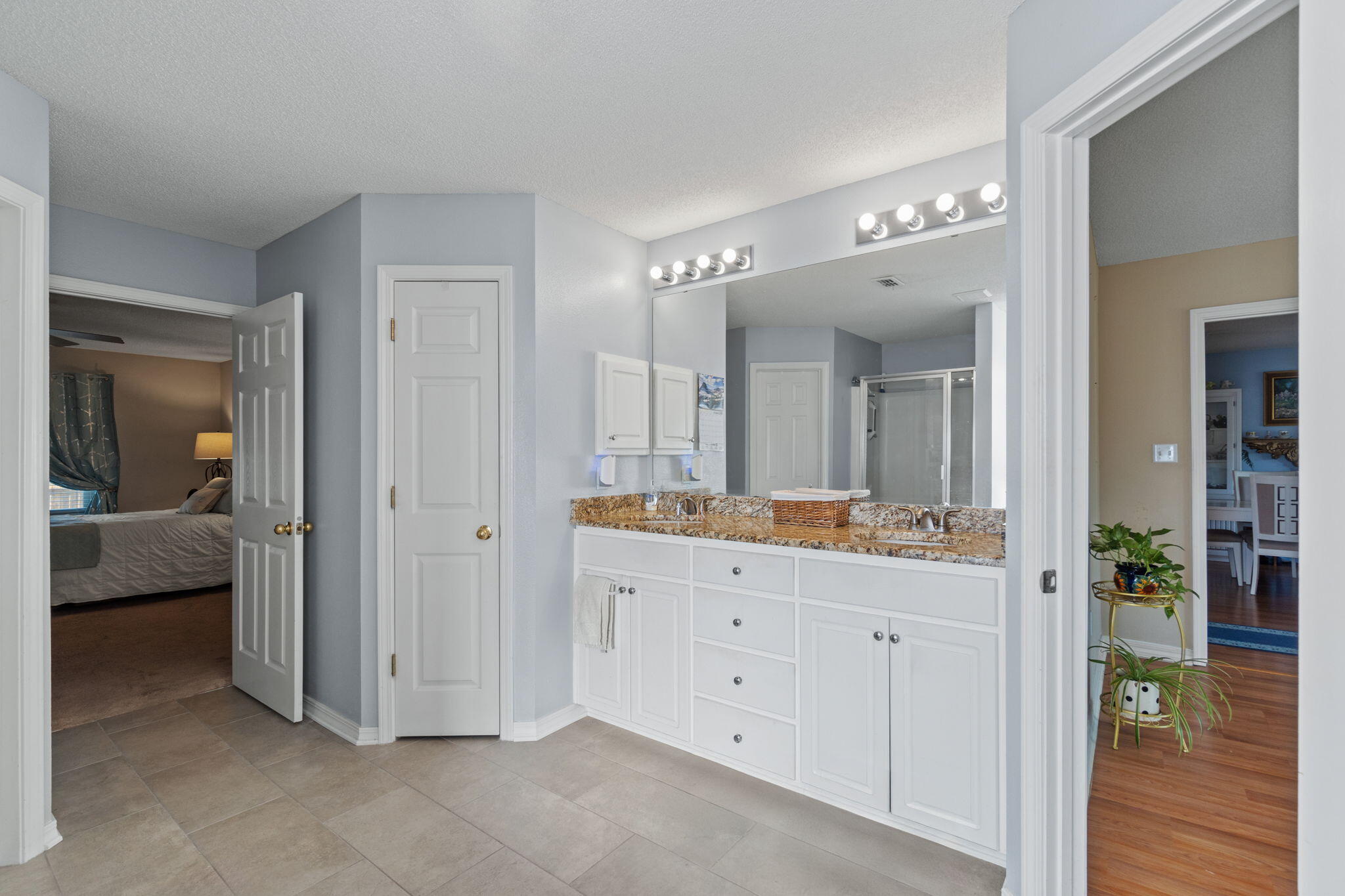 2121 Ortega Street Navarre, FL 32566 - Photo 23 of 47 a spacious bathroom with a granite countertop sink a mirror and a