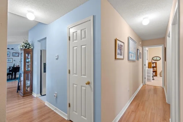 a bedroom with a bed chandelier and a window