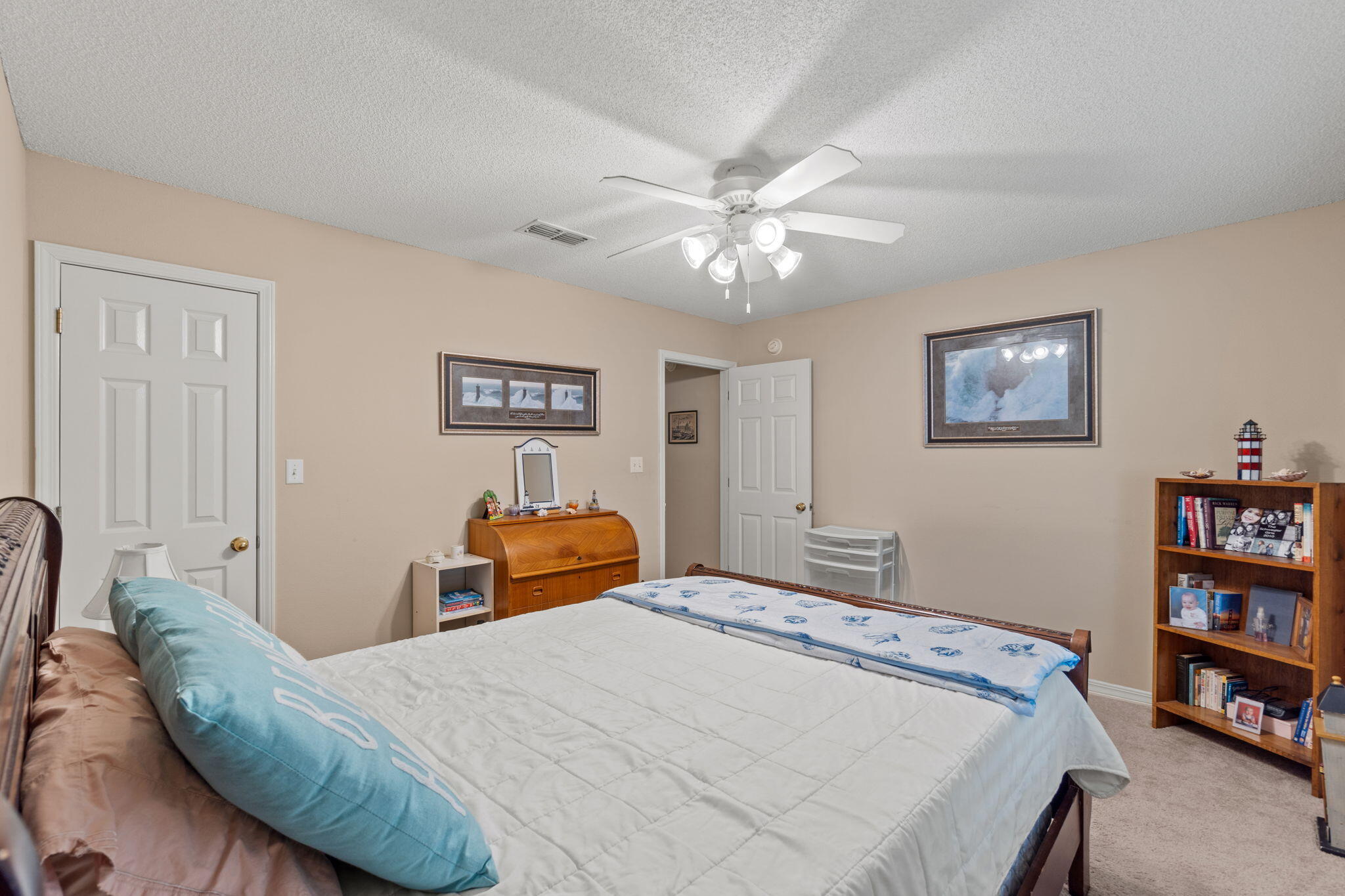2121 Ortega Street Navarre, FL 32566 - Photo 26 of 47 a bedroom with a bed dresser and book shelf