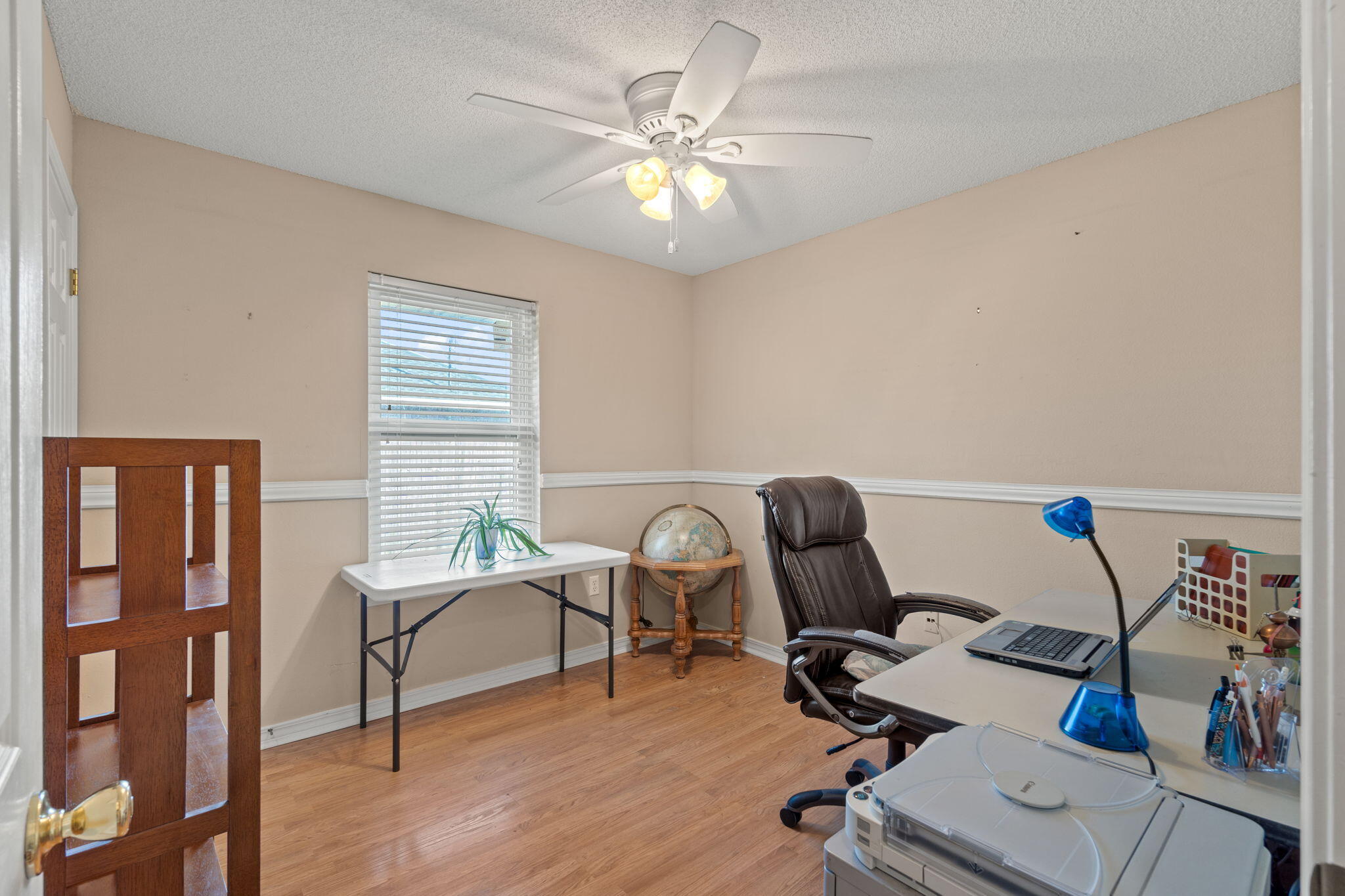 2121 Ortega Street Navarre, FL 32566 - Photo 27 of 47 a work room with furniture and wooden floor