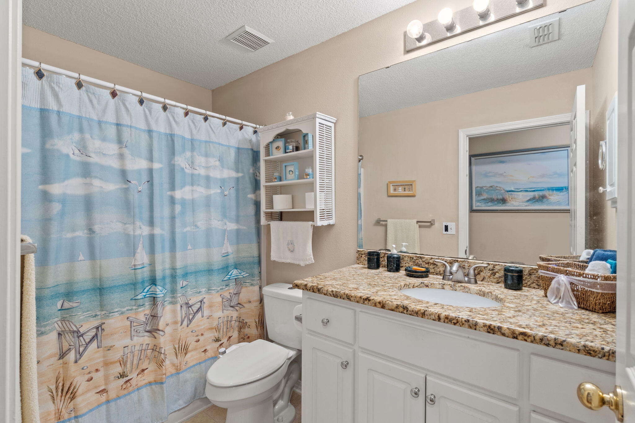 2121 Ortega Street Navarre, FL 32566 - Photo 29 of 47 a bathroom with a granite countertop sink a toilet a glass door shower and a mirror