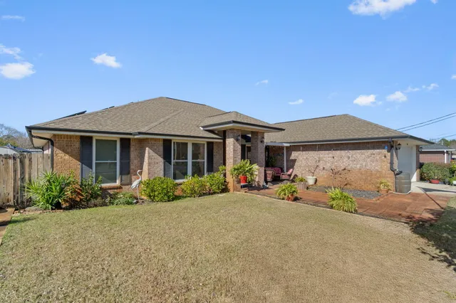 a front view of a house with a garden and porch