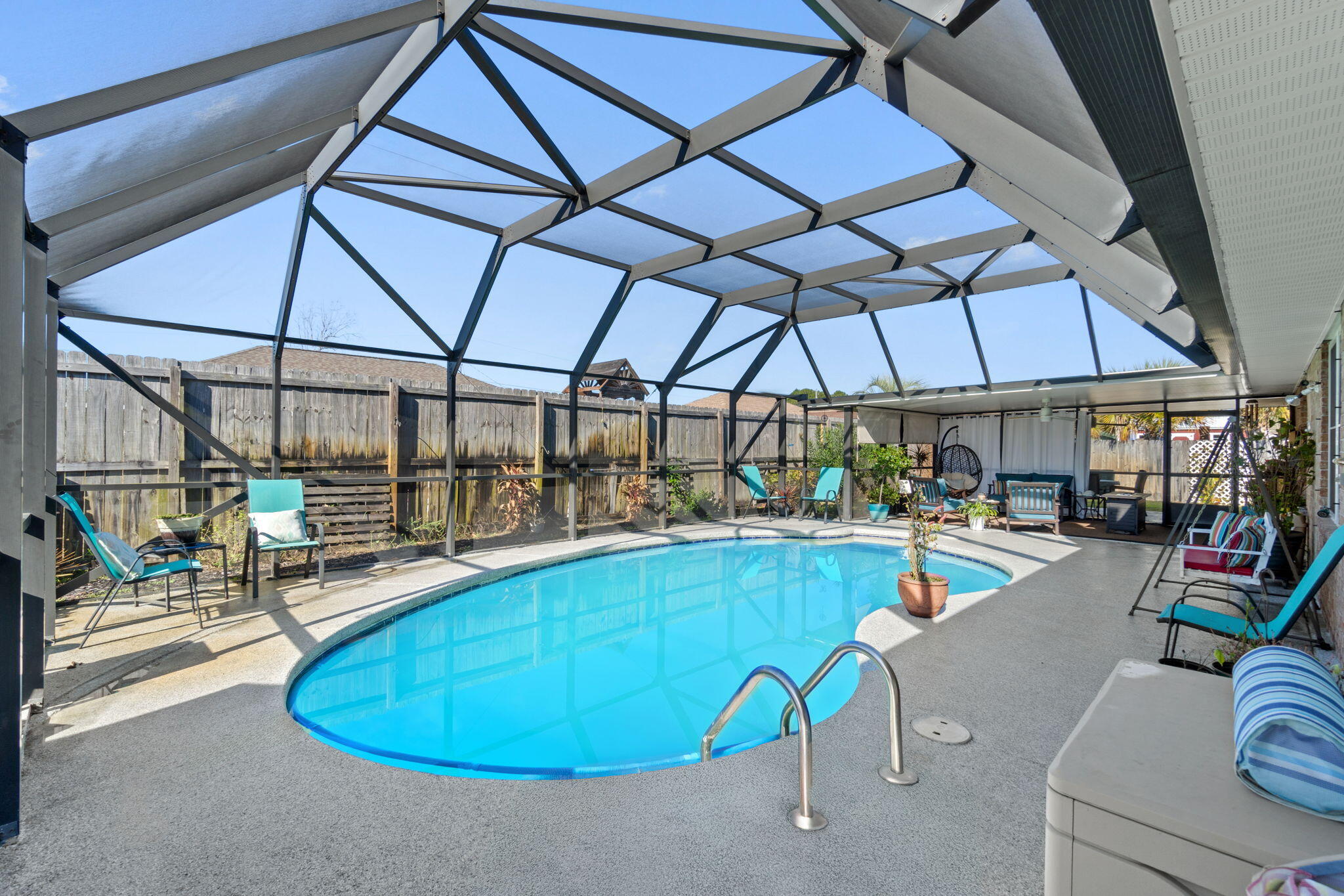 2121 Ortega Street Navarre, FL 32566 - Photo 32 of 47 a view of a swimming pool with a lounge chairs