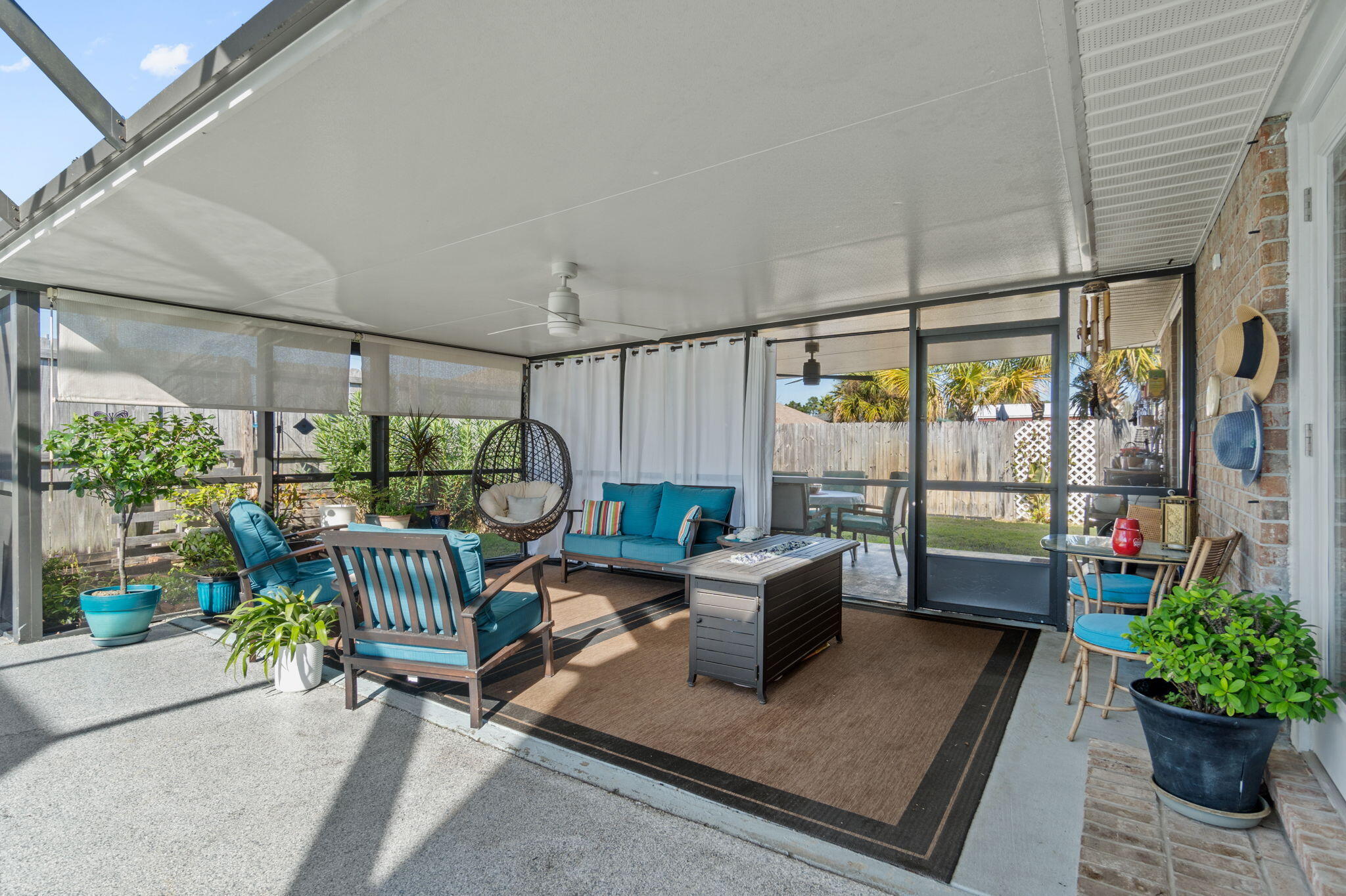 2121 Ortega Street Navarre, FL 32566 - Photo 34 of 47 a outdoor living space with furniture and a potted plant