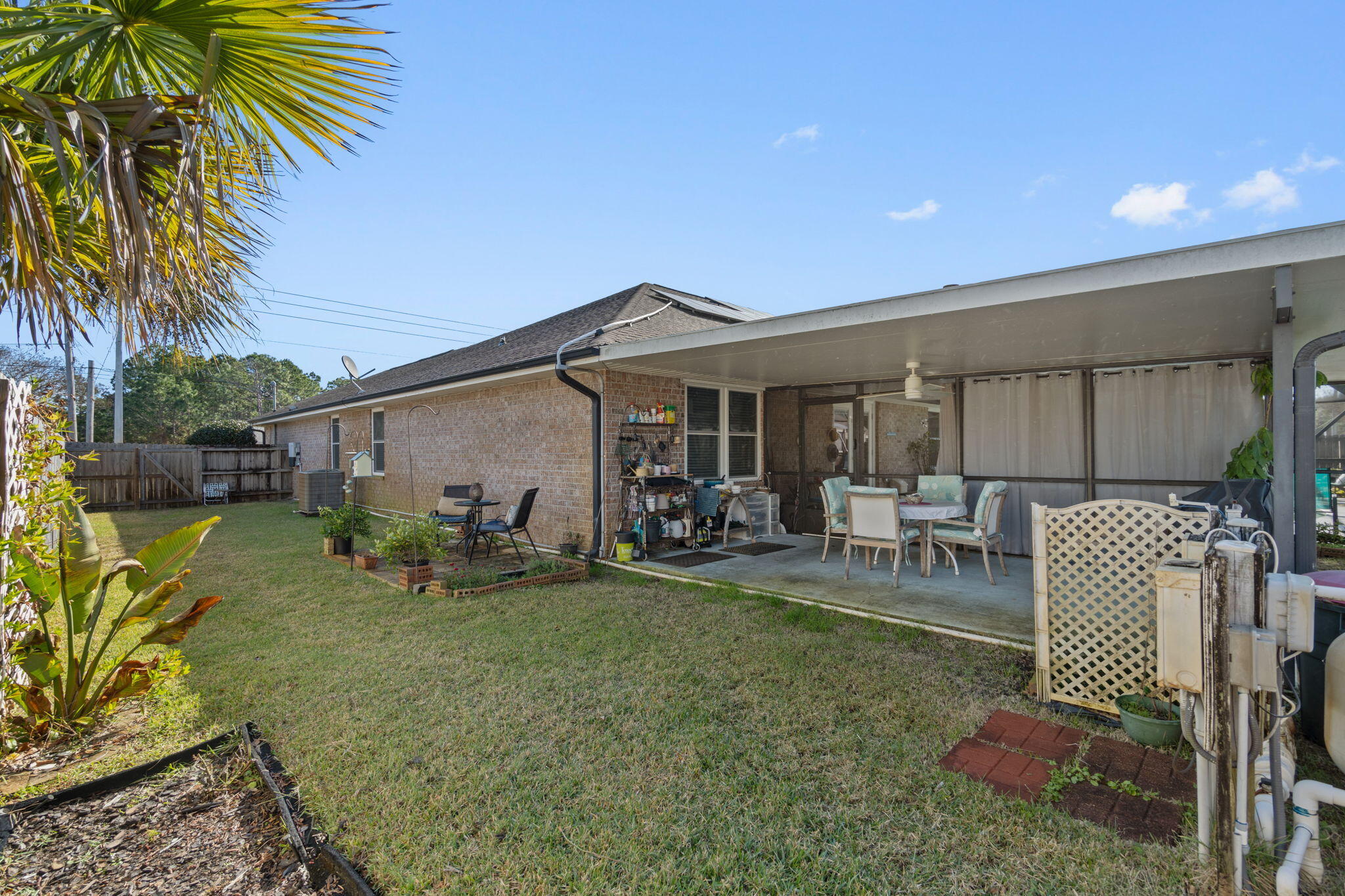 2121 Ortega Street Navarre, FL 32566 - Photo 36 of 47 a view of a house with backyard porch and sitting area