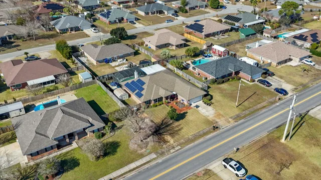 an aerial view of a house with a ocean view