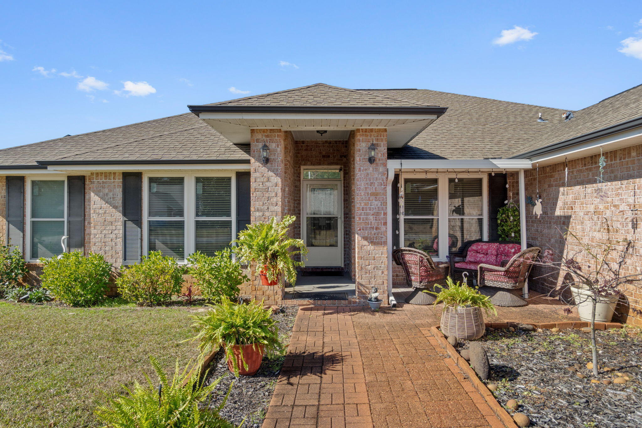 2121 Ortega Street Navarre, FL 32566 - Photo 4 of 47 a front view of a house with garden