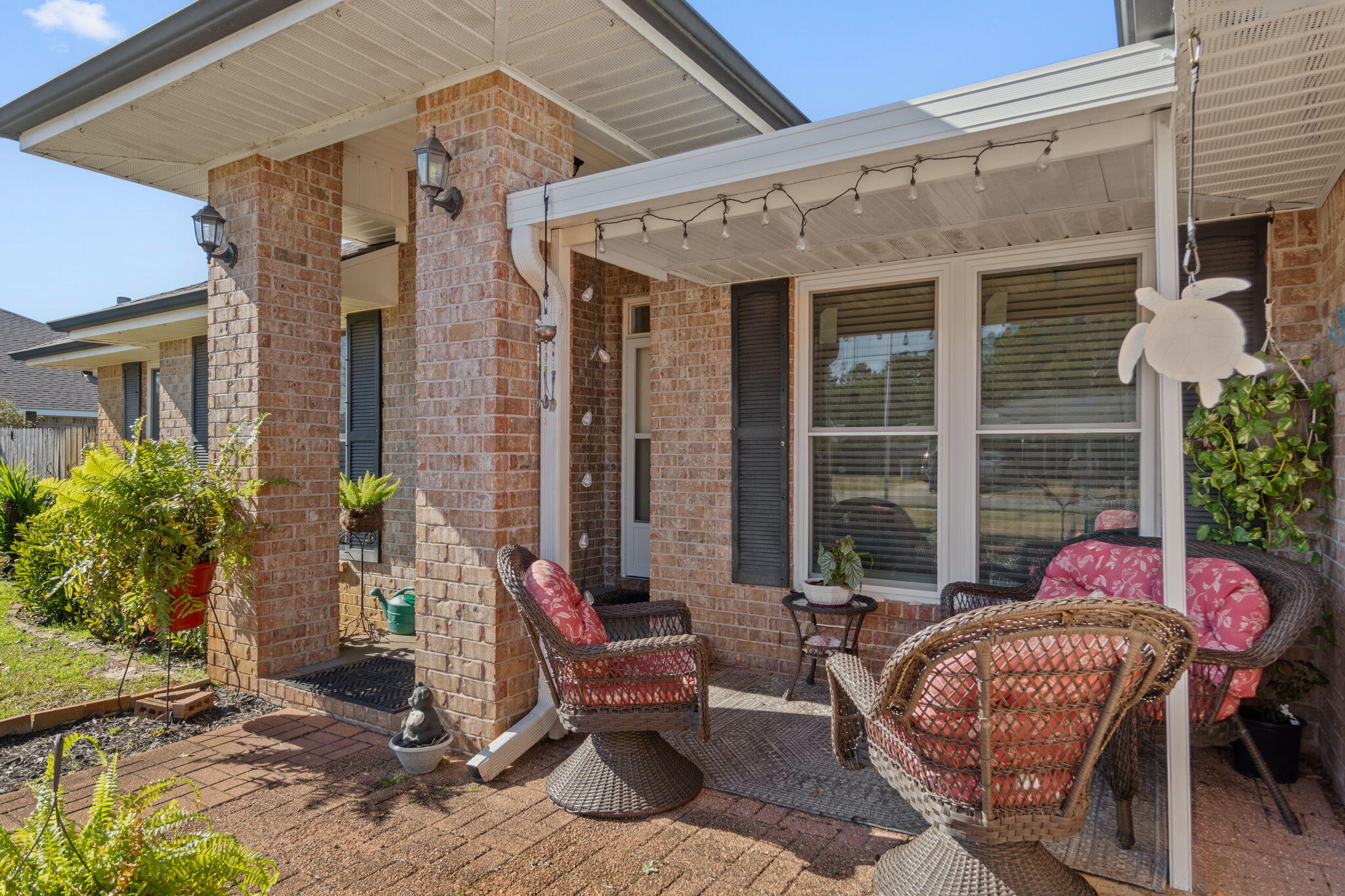 2121 Ortega Street Navarre, FL 32566 - Photo 5 of 47 a view of a patio with a table and chairs and potted plants