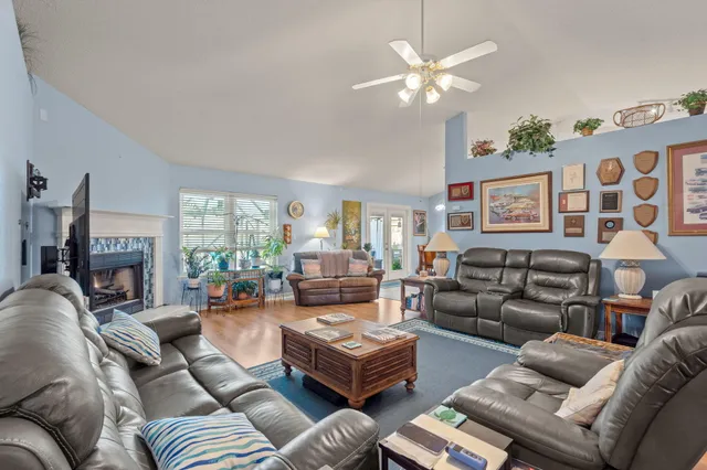 a living room with furniture ceiling fan and a fireplace