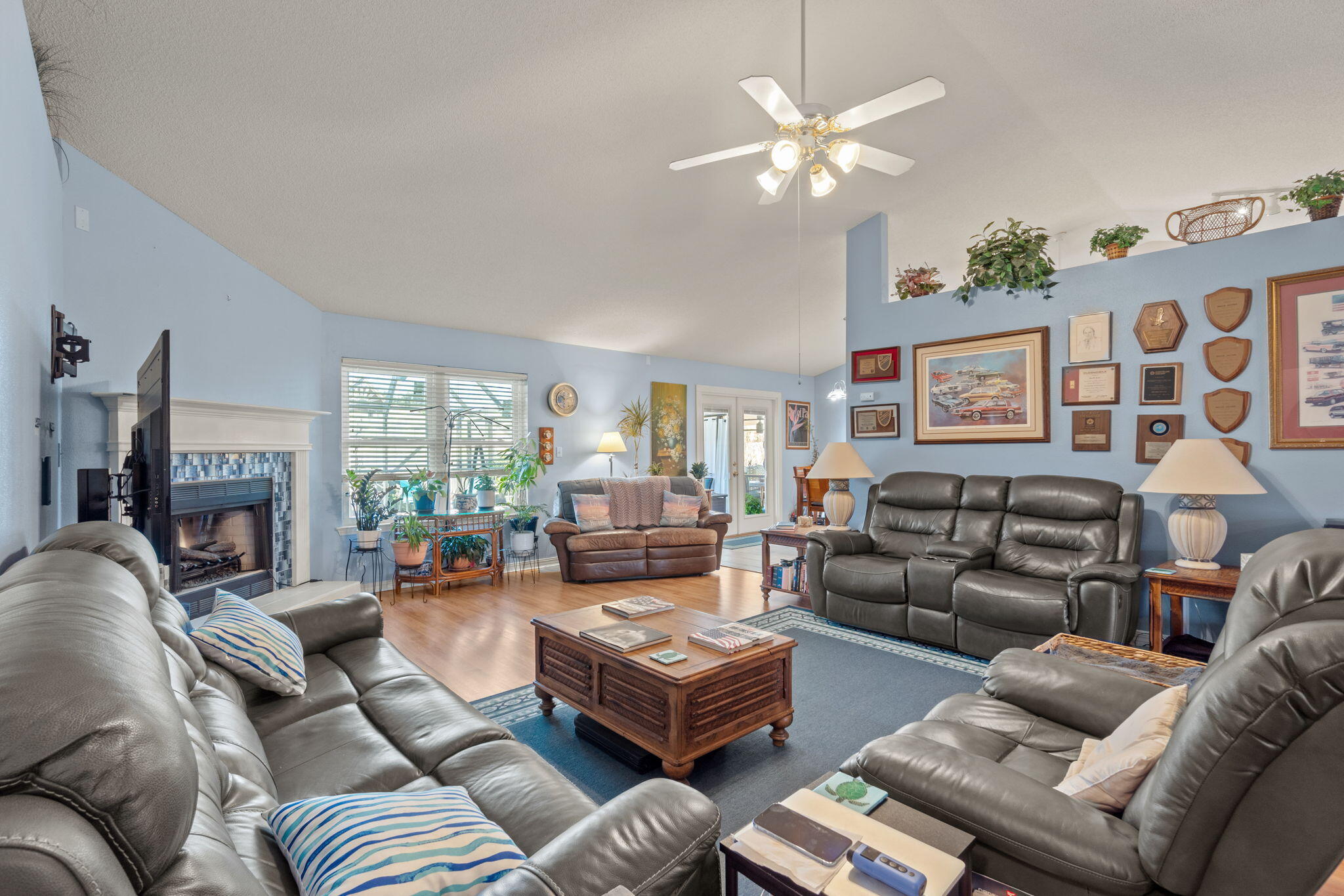 2121 Ortega Street Navarre, FL 32566 - Photo 8 of 47 a living room with furniture ceiling fan and a fireplace