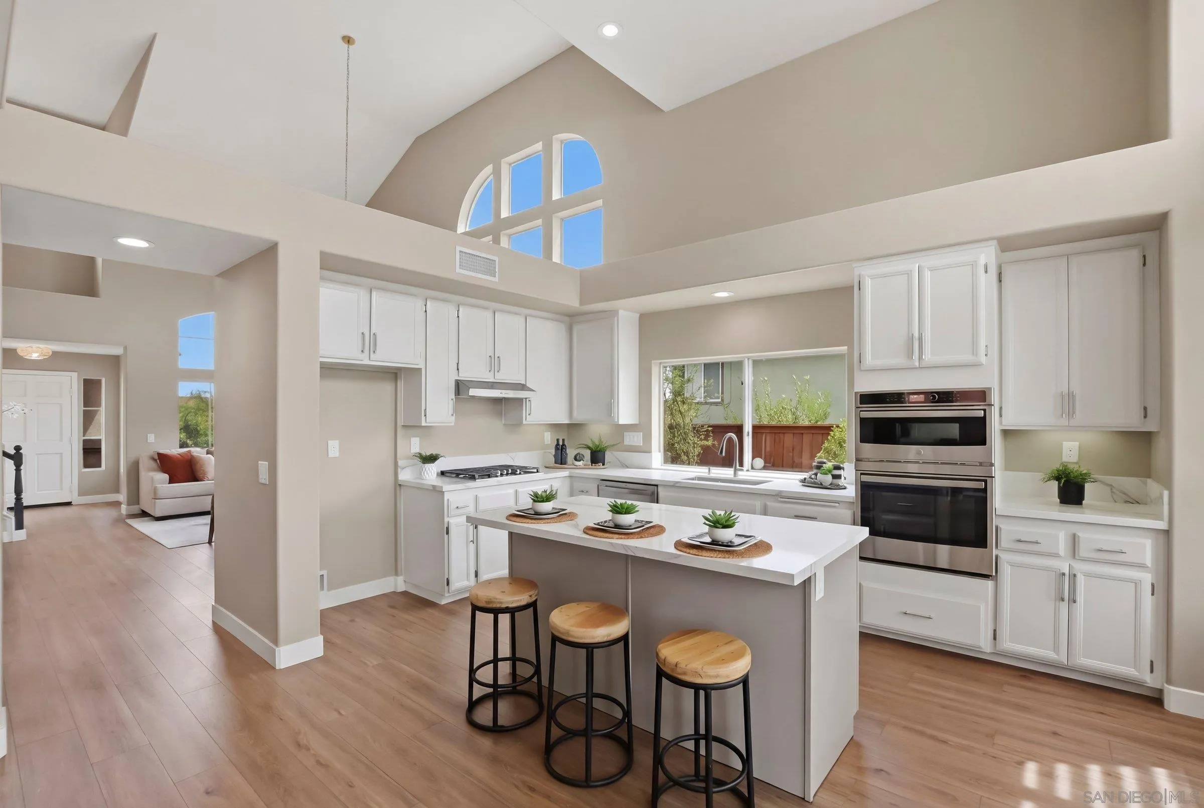 12182 Mannix Road San Diego, CA 92129 - Photo 15 of 43 a kitchen with a center island appliances and cabinets