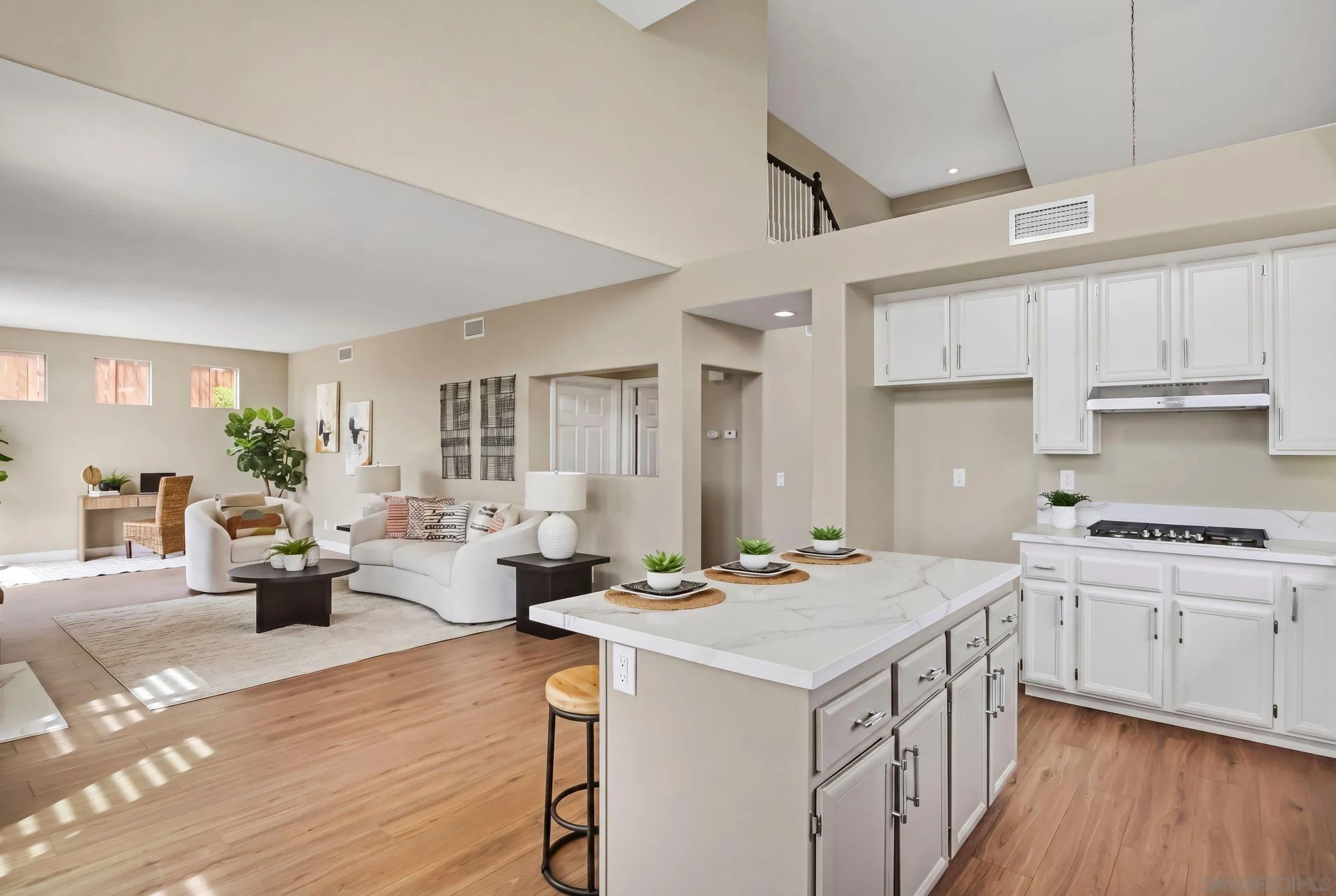12182 Mannix Road San Diego, CA 92129 - Photo 16 of 43 a kitchen that has a lot of cabinets a sink and wooden floor