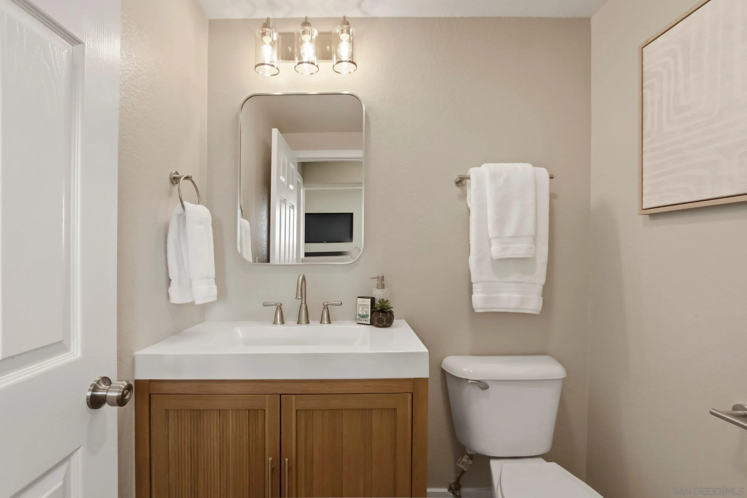 12182 Mannix Road San Diego, CA 92129 - Photo 19 of 43 a bathroom with a toilet sink and mirror