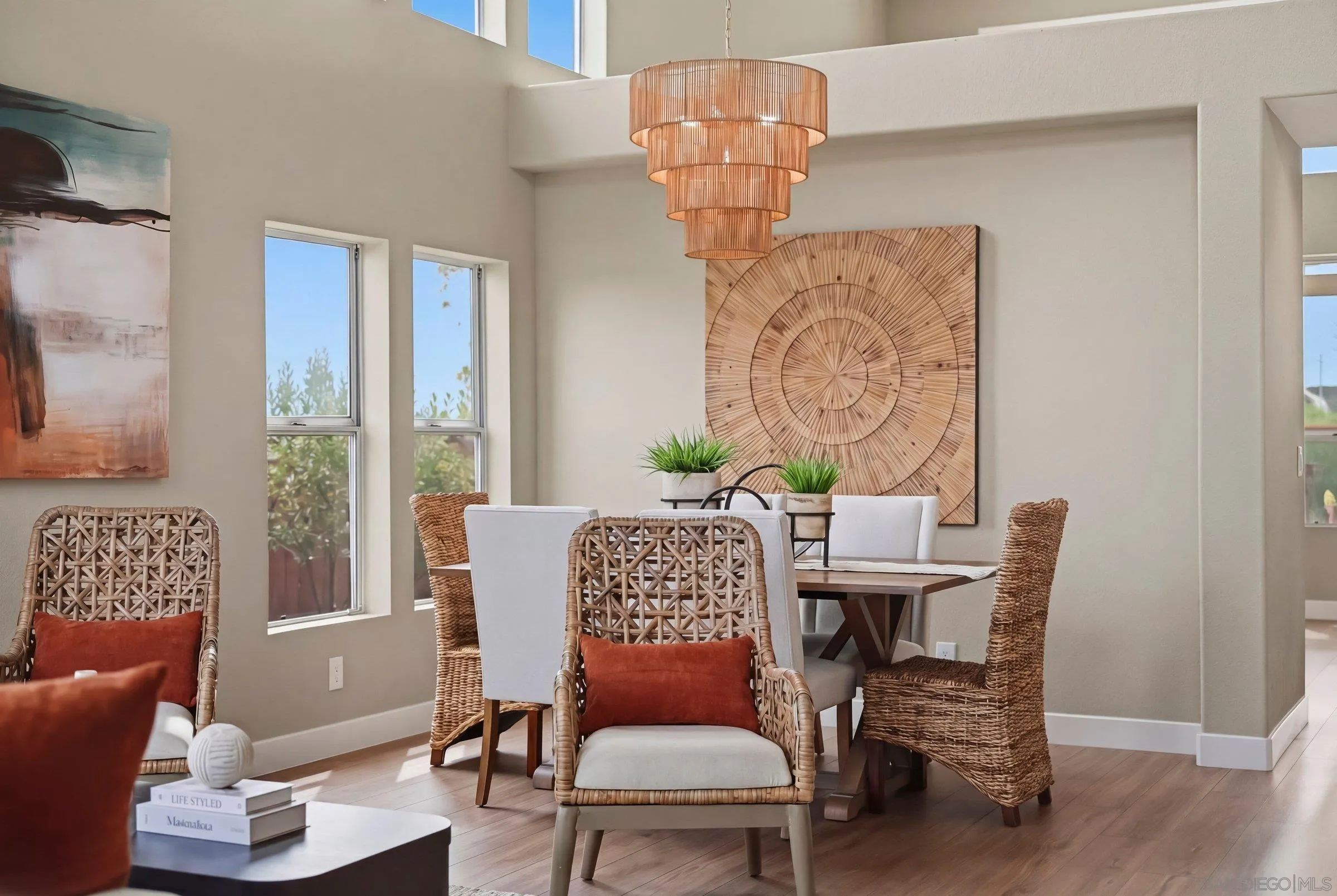12182 Mannix Road San Diego, CA 92129 - Photo 20 of 43 a view of a dining room with furniture wooden floor and a chandelier