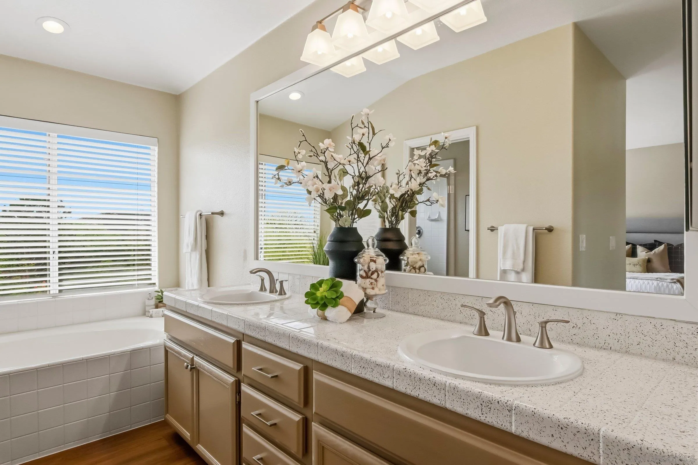 12182 Mannix Road San Diego, CA 92129 - Photo 25 of 43 a bathroom with a double vanity sink and a mirror