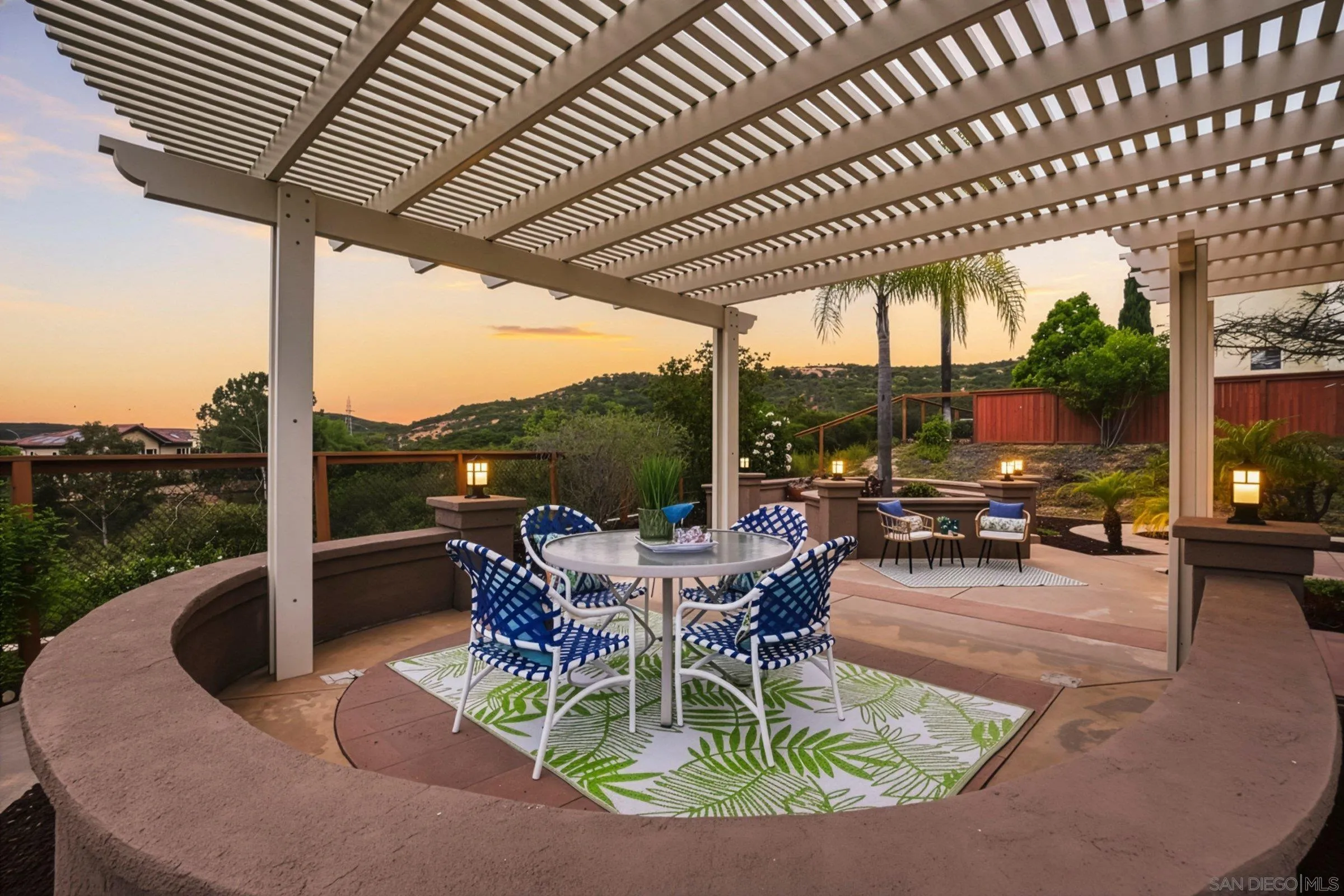 12182 Mannix Road San Diego, CA 92129 - Photo 4 of 43 a view of a patio with a table chairs and a patio