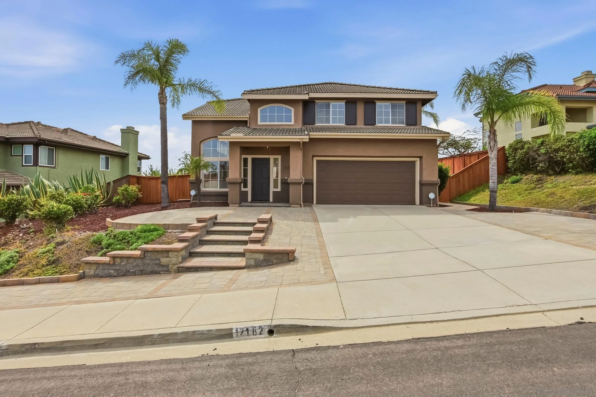 12182 Mannix Road San Diego, CA 92129 - Photo 7 of 43 a front view of a house with a yard and garage