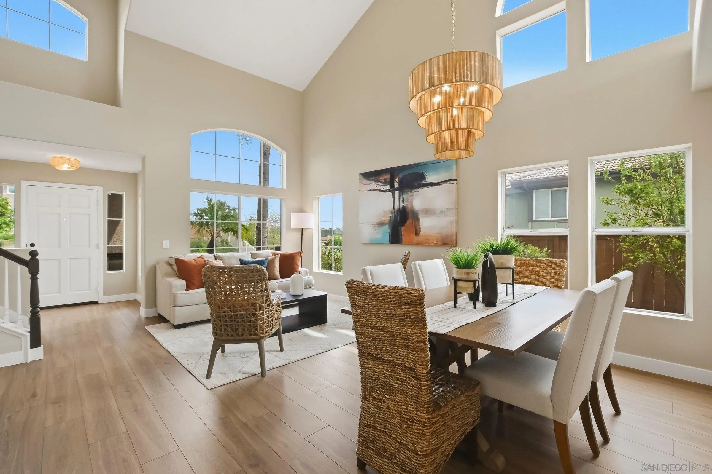 12182 Mannix Road San Diego, CA 92129 - Photo 10 of 43 a dining room with furniture a large window and wooden floor
